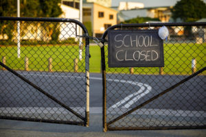 School Closed sign on a locked gate